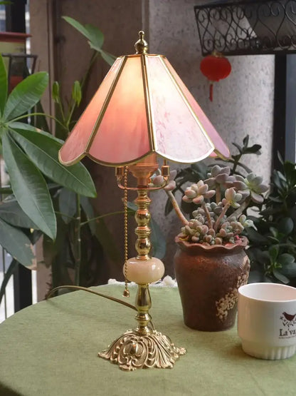 Vintage-style desk lamp with pink stained glass shade and ornate brass base ideal for decorbites brass desk lamp use