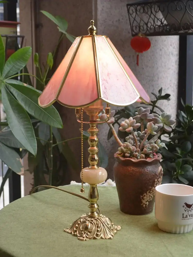 Vintage-style desk lamp with pink stained glass shade and ornate brass base ideal for decorbites brass desk lamp use