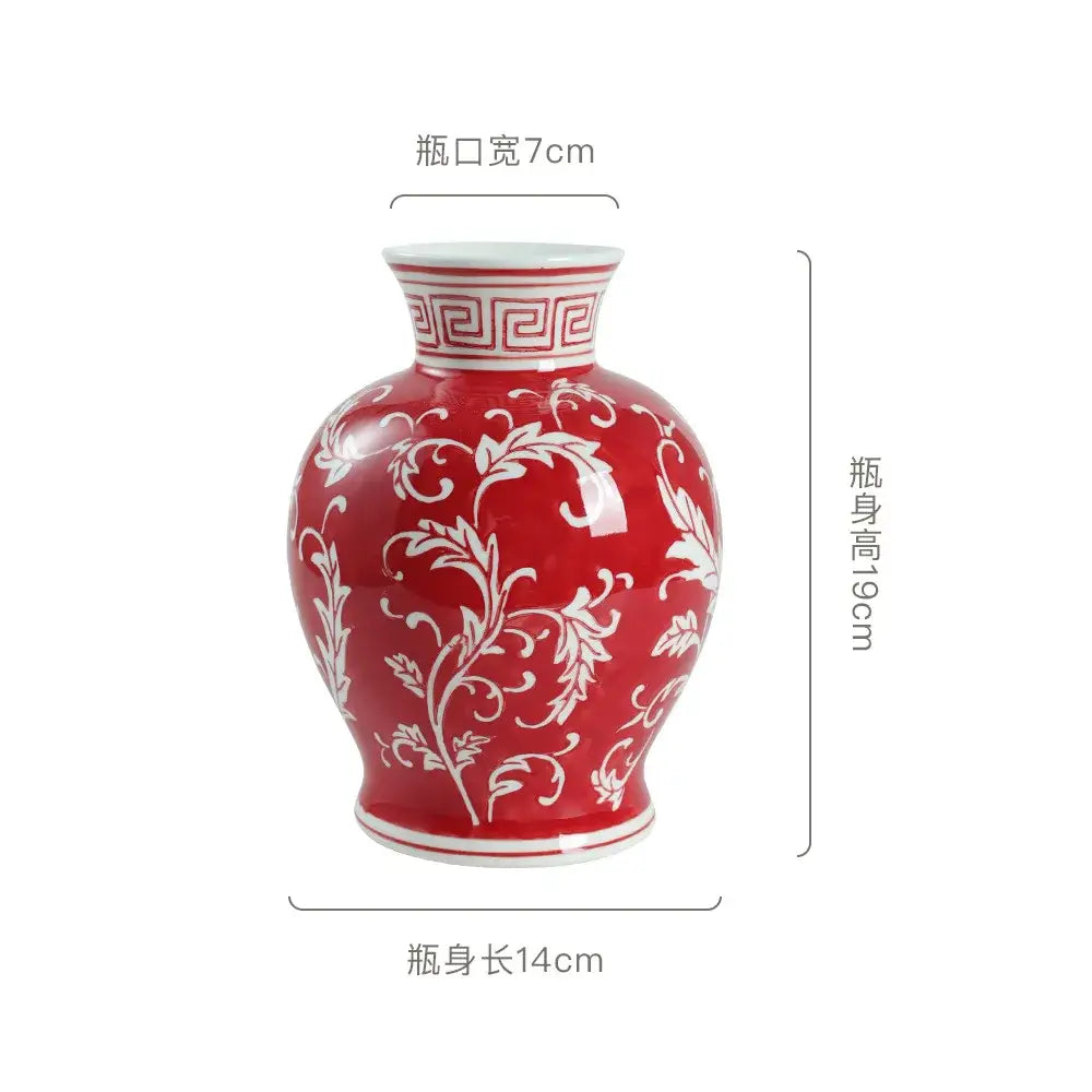 A glossy red ceramic vase with white floral patterns, featuring a narrow neck for retro pink and white porcelain vase decor