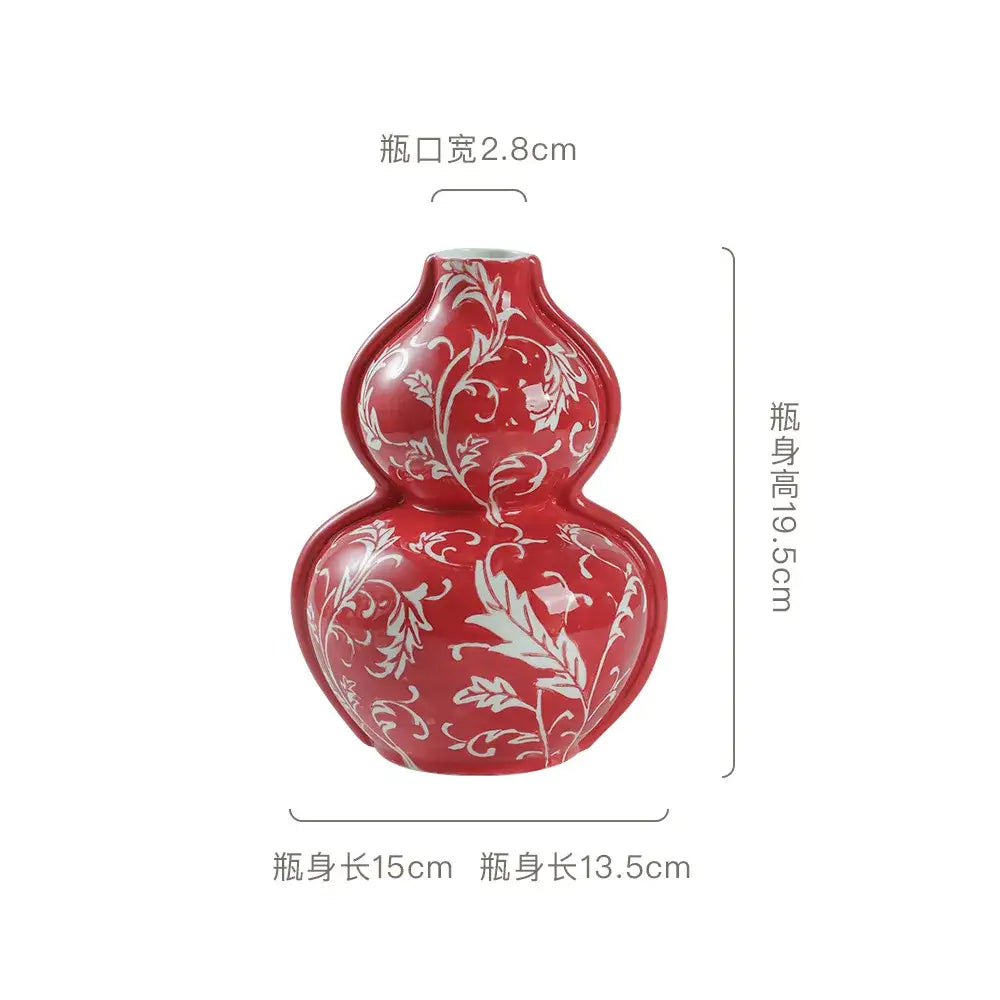 A glossy red ceramic retro gourd vase with intricate white floral patterns ideal for living room decorbites blue white style