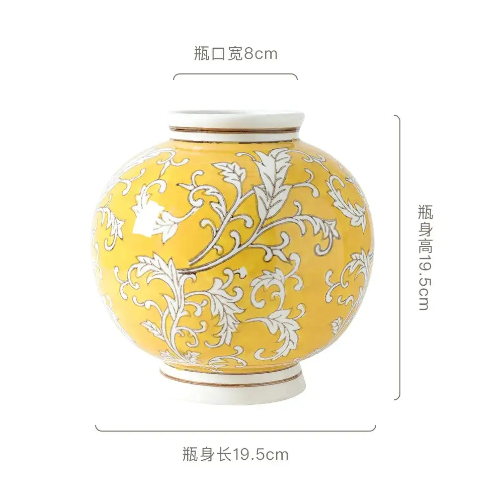 A round glossy yellow ceramic vase with white floral patterns and cream accents for retro living room decorbites blue white style