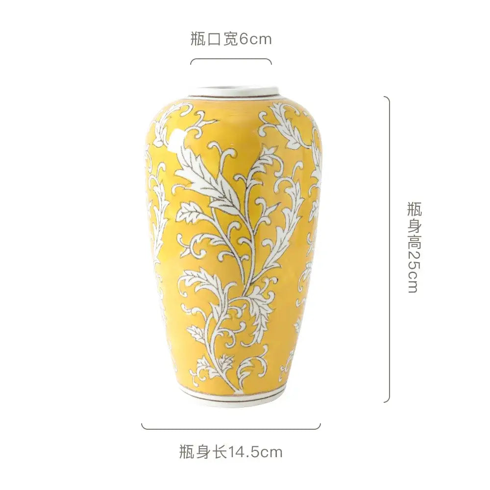 A tall glossy yellow ceramic vase with intricate white floral patterns for living room decorbites blue white style