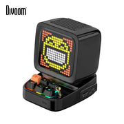 Black retro pixel art bluetooth speaker with led display board showing yellow orange graphics above colorful keyboard keys