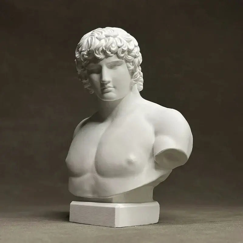 White marble bust of a muscular male figure with curly hair on a rectangular base by decorbites antinous retro plaster sculpture