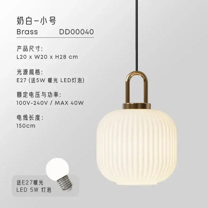 Cream-colored ribbed glass pendant light with brass-finished fixture and black cord for dining room pendant lights