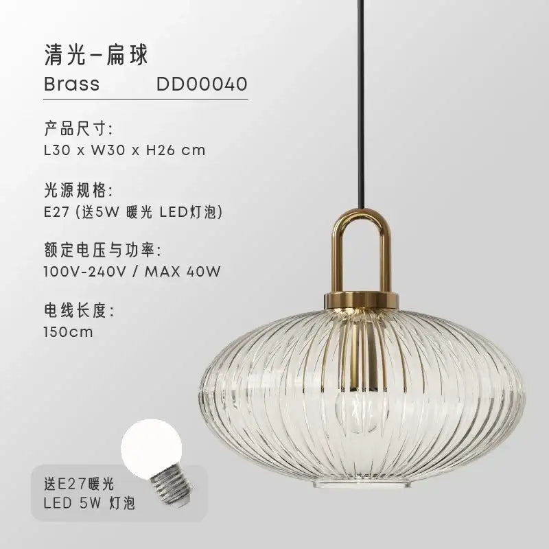 A modern brass glass pendant light with a clear ribbed shade and elegant curved metal fixture for dining room