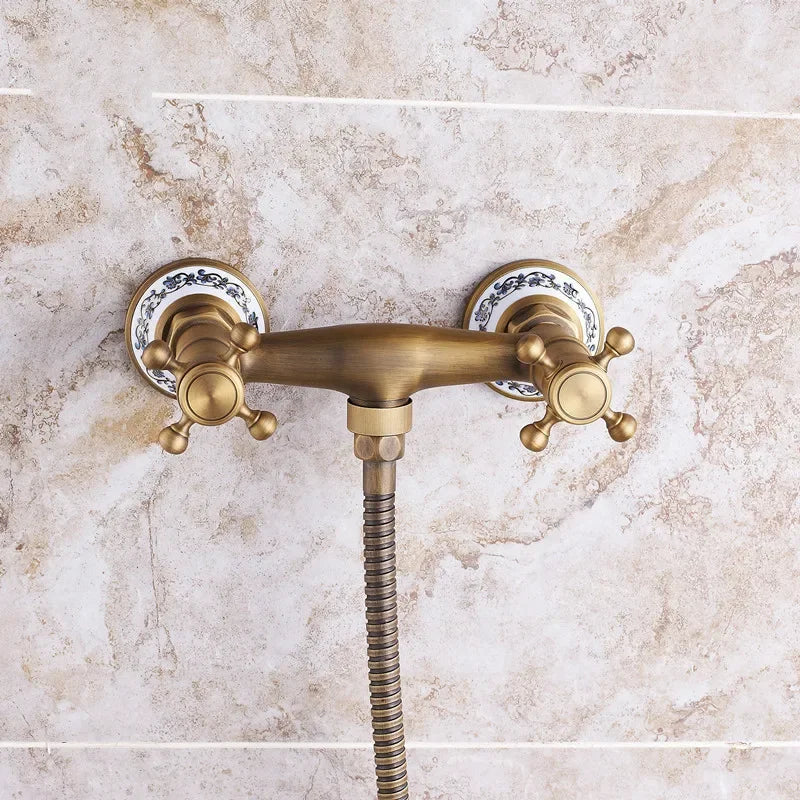 Antique brass double-handle shower faucet with ornate ceramic escutcheons and flexible hose for wall mount use