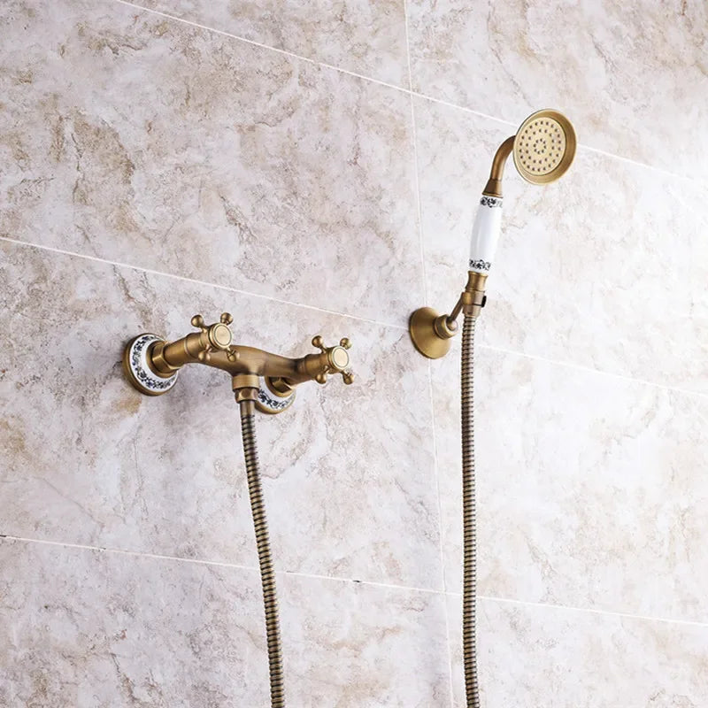 Antique brass bathroom faucet set with ceramic handles and matching handheld showerhead for wall mount use