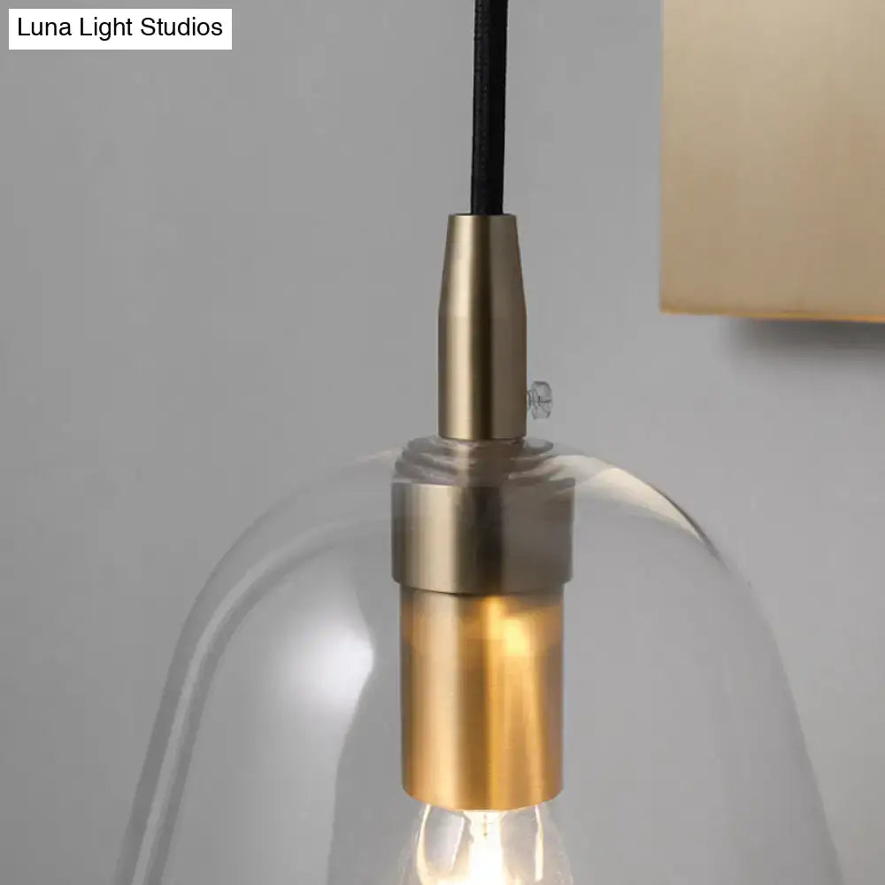 Retro style brass wall light with clear glass shade featuring e14 bulb base for bedroom sconce lighting