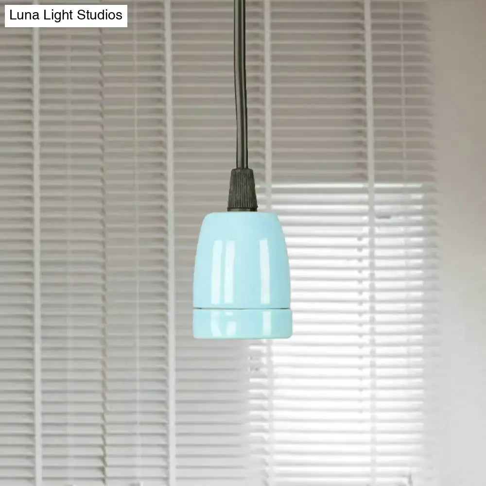 A sleek light blue ceramic pendant light with matte finish and black cord from decorbites black red ceramic line