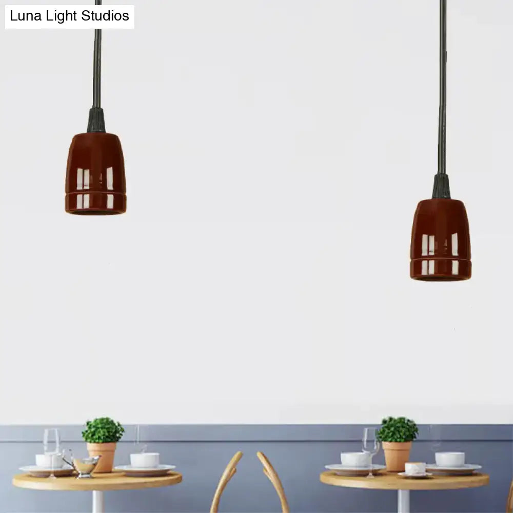 Two decorbites™ retro style mini hanging pendant lights with black cords and glossy red ceramic ceiling shades