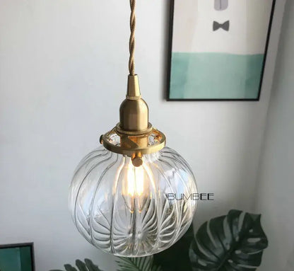 Retro teal and brass glass pendant chandelier featuring a clear ribbed glass pendant light with brass glass pendant fixture