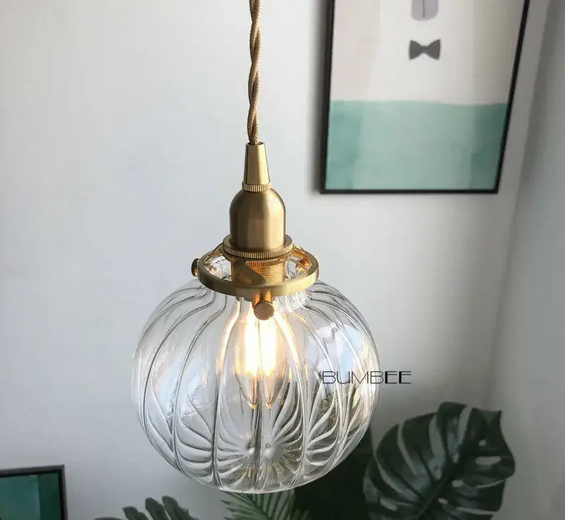 Retro teal and brass glass pendant chandelier featuring a clear ribbed glass pendant light with brass glass pendant fixture