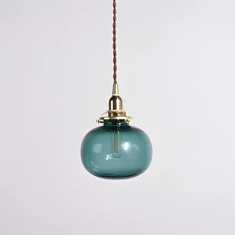 Retro teal and brass glass pendant chandelier with a teal globe, brass hardware, and braided cord for bedroom decorbites brass glass