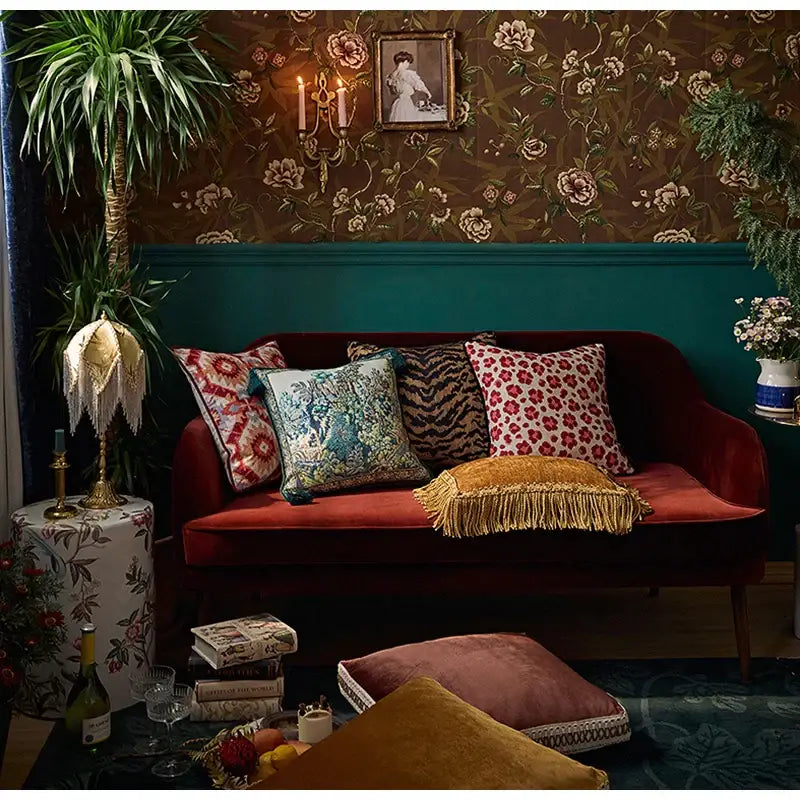 Rich burgundy velvet sofa with teal velvet retro garden scene cushion covers featuring tassels and patterned throw pillows decorbites american luxe american luxe retro