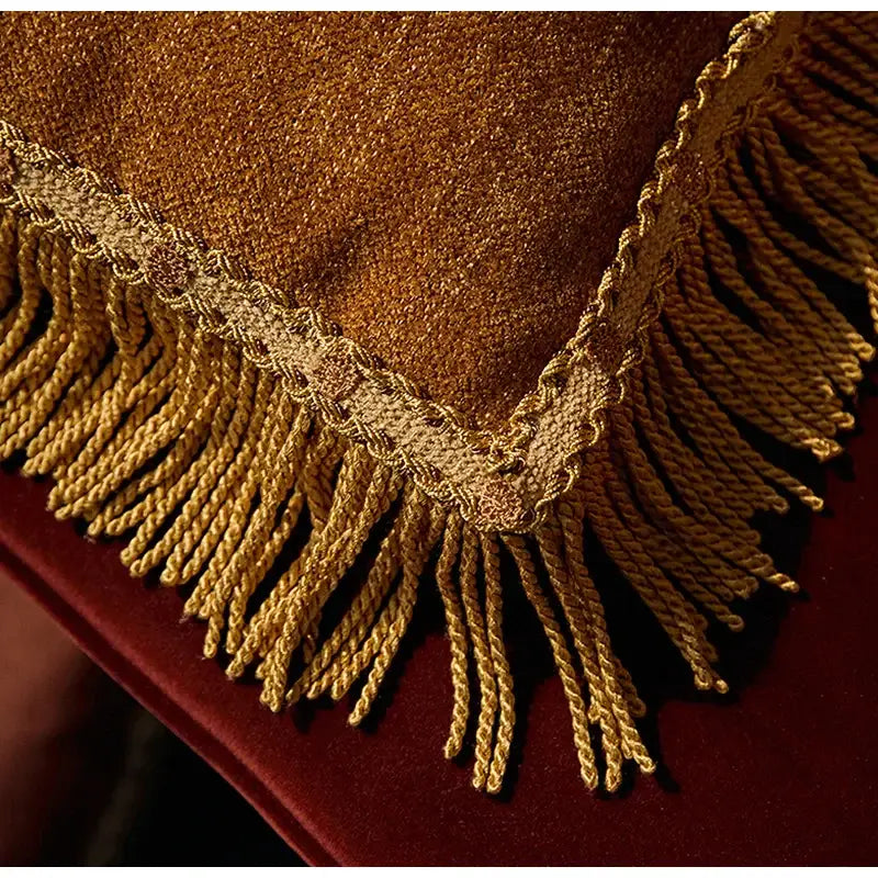 Golden fringed cushion cover with textured shimmering fabric and intricate lace trim for american luxe retro decorbites living room