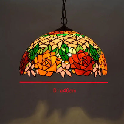 Retro Tiffany style glass chandelier pendant with colorful glass floral patterns in orange red green and yellow hues by decorbites