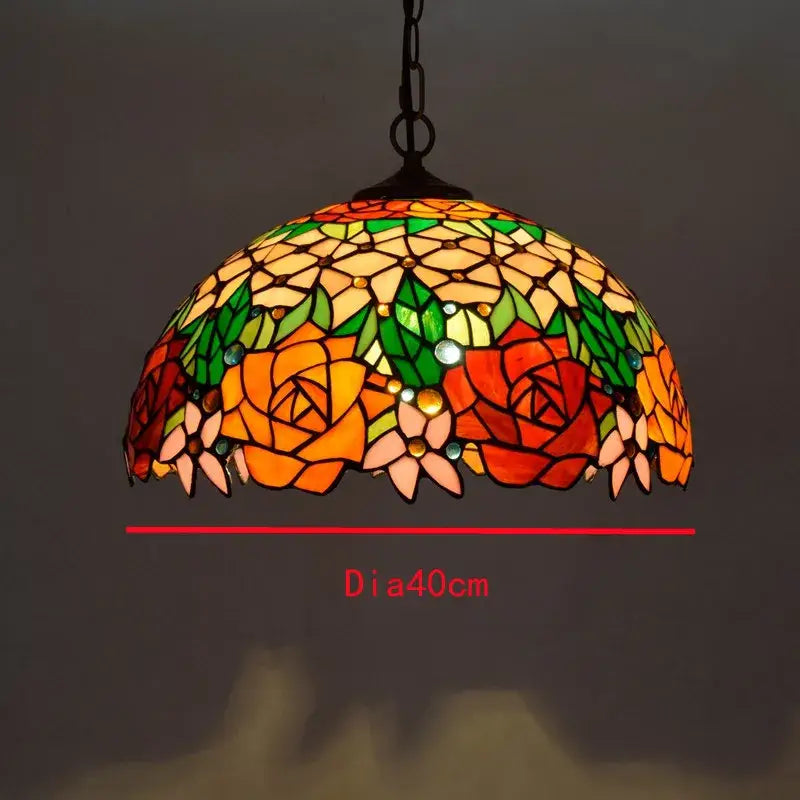 Retro Tiffany style glass chandelier pendant with colorful glass floral patterns in orange red green and yellow hues by decorbites