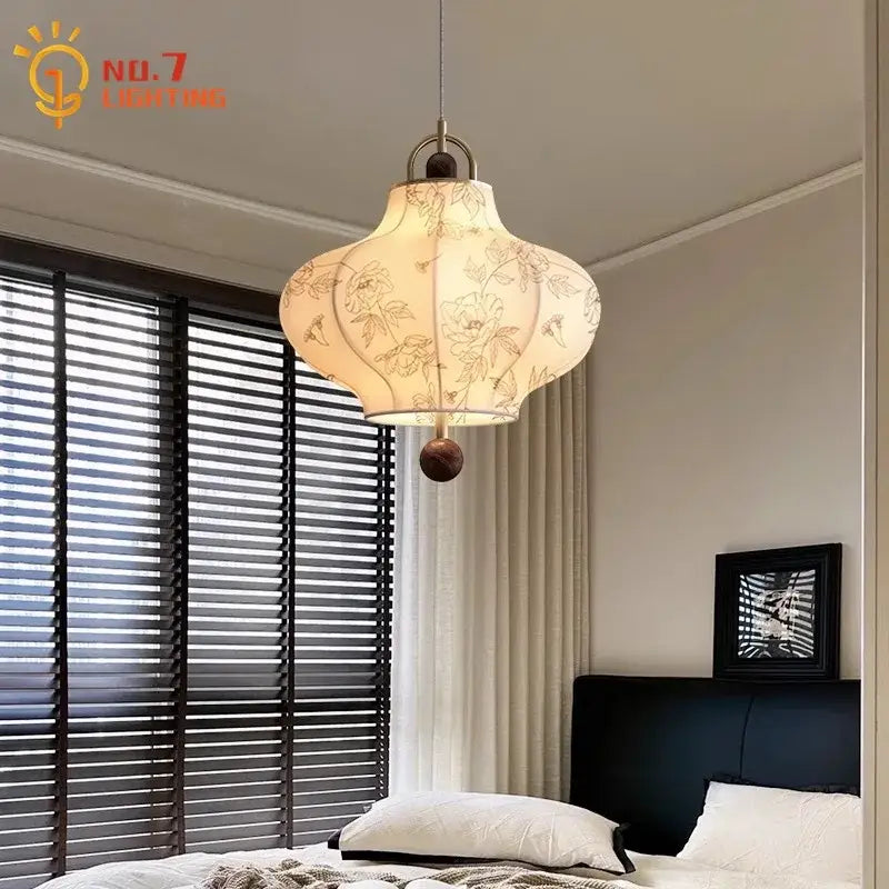 Retro pendant lights featuring warm-toned cream fabric with floral embroidery and dark wood accents by decorbites wabi-sabi