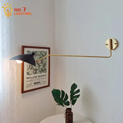 Gold-toned wall lamp with swing arm and matte black shade for bedroom reading light by decorbites copper swing