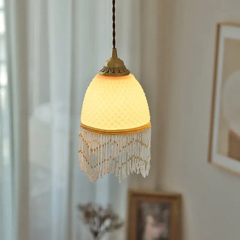 A warm off-white decorbites glass tassels led pendant light with textured glass shade for dining room decor