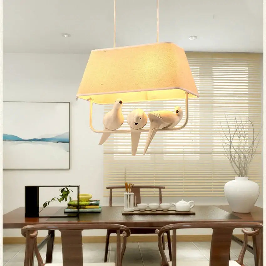 Retro white resin bird cage chandelier pendant light with warm-toned rectangular shade and three ceramic doves decorbites bird cage