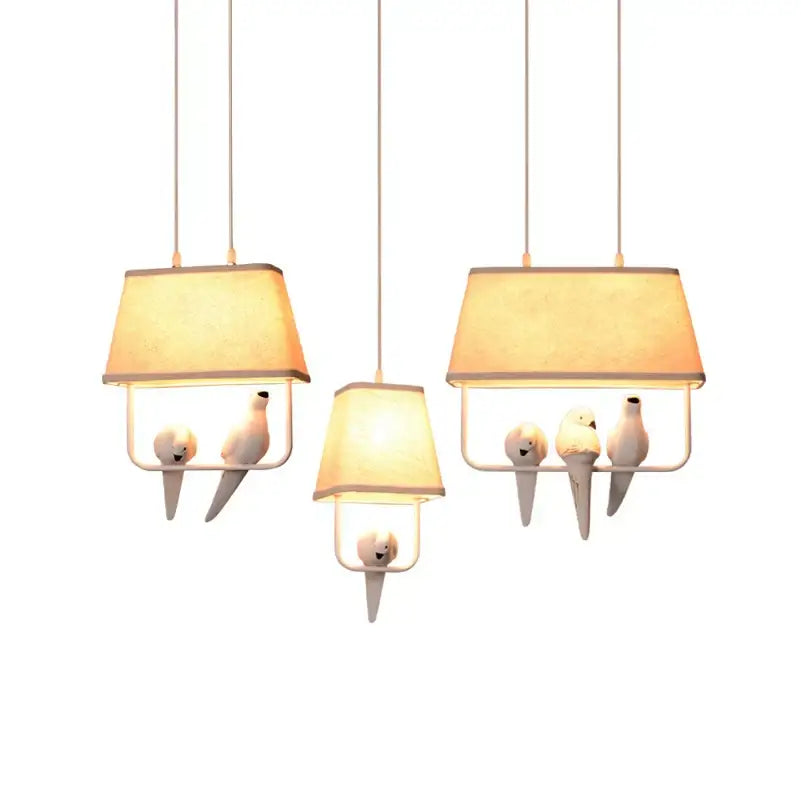 Retro white resin bird cage chandelier with warm beige fabric shades and sculpted dove figures for dining room decorbites bird cage