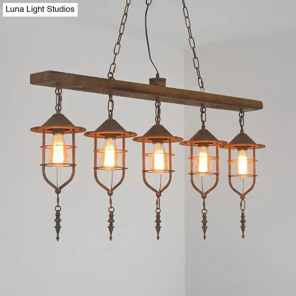 Industrial-style ceiling light with rustic wooden beam and five iron cage lanterns as a dining room lighting fixture