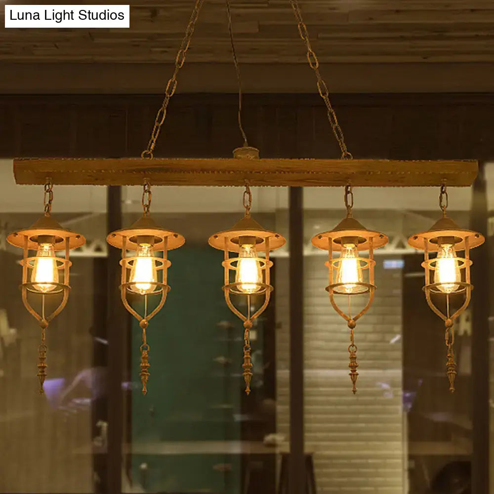 Rustic wooden ceiling light with five brass-finished lanterns and iron cage design for dining room lighting fixture