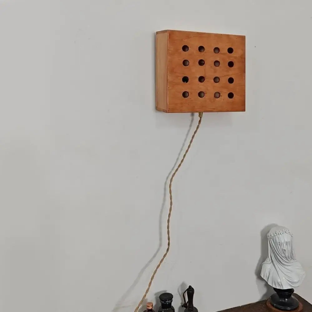 Retro wooden cave box wall light with a grid of circular holes and braided cord for bedroom decorbites cave box lighting