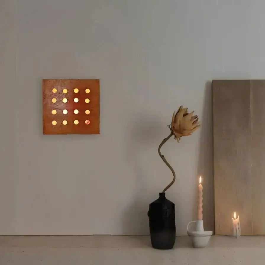 A square copper wall light with glowing circular lights from decorbites cave box retro wooden cave box for bedroom lighting