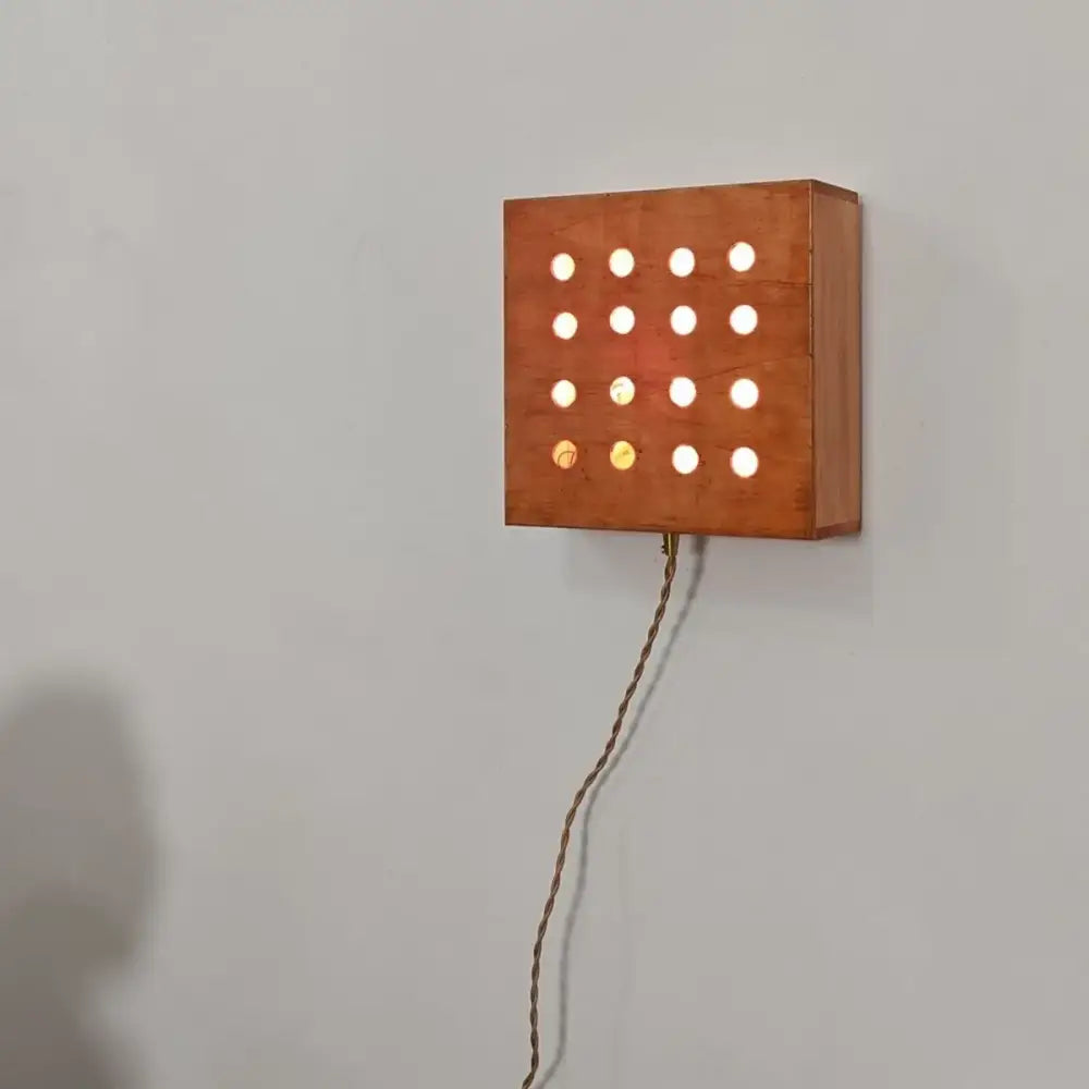 Retro wooden cave box wall light with warm-toned wood and circular cutouts emitting soft bedroom illumination decorbites cave box