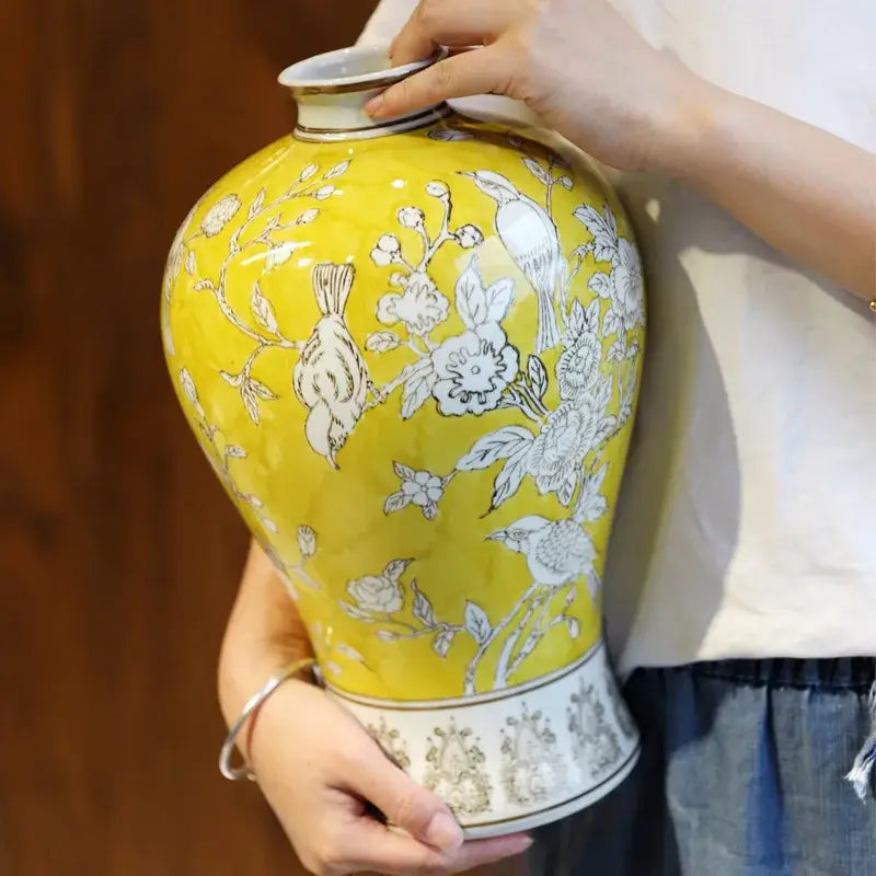 Retro yellow and white porcelain vase with floral and bird motifs featuring ornate silver detailing for living room decorbites blue white style