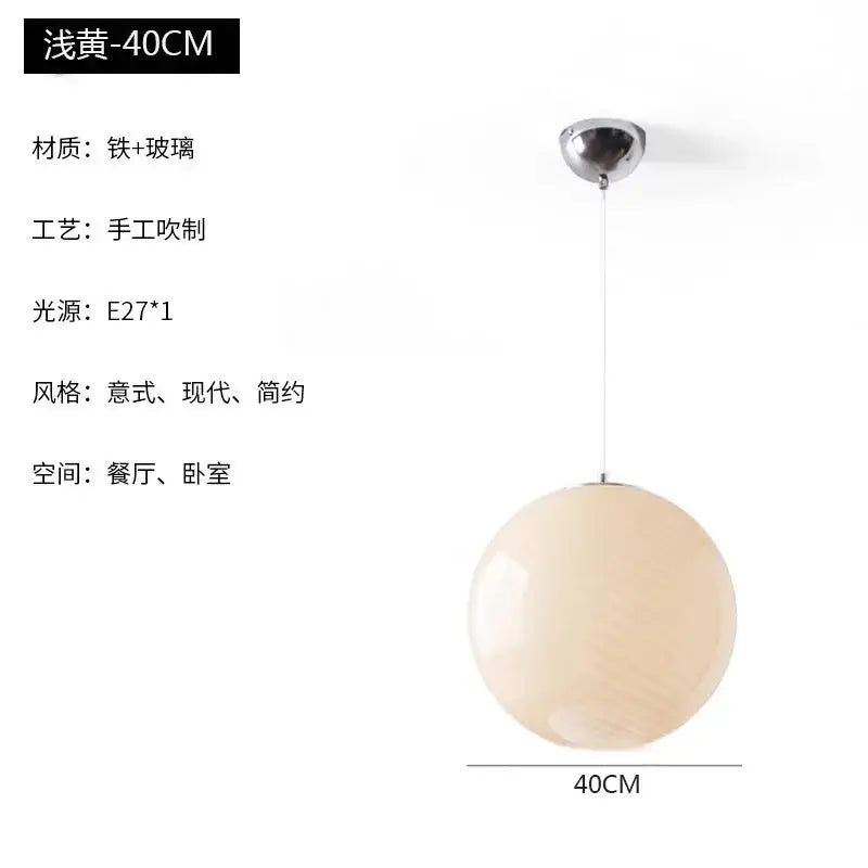 A 40cm spherical matte pale yellow glass pendant light with chrome fixture ideal for dining room pendant lights