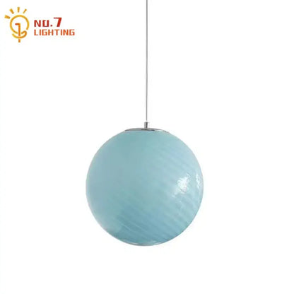 A sleek light blue glass pendant light with a textured finish and polished chrome fixture for dining room use