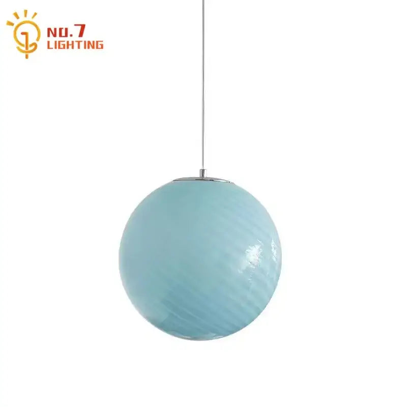 A sleek light blue glass pendant light with a textured finish and polished chrome fixture for dining room use