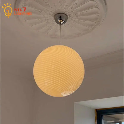 Warm-toned ribbed amber glass pendant light with chrome fixture designed for dining room glass pendant lights