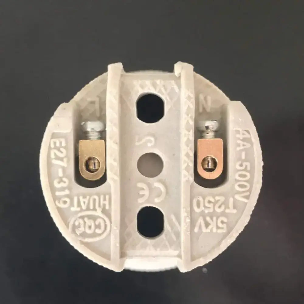 White ceramic ribbed beige decorbites creamic e27 socket lamp holder base with brass screws and molded markings visible from back side
