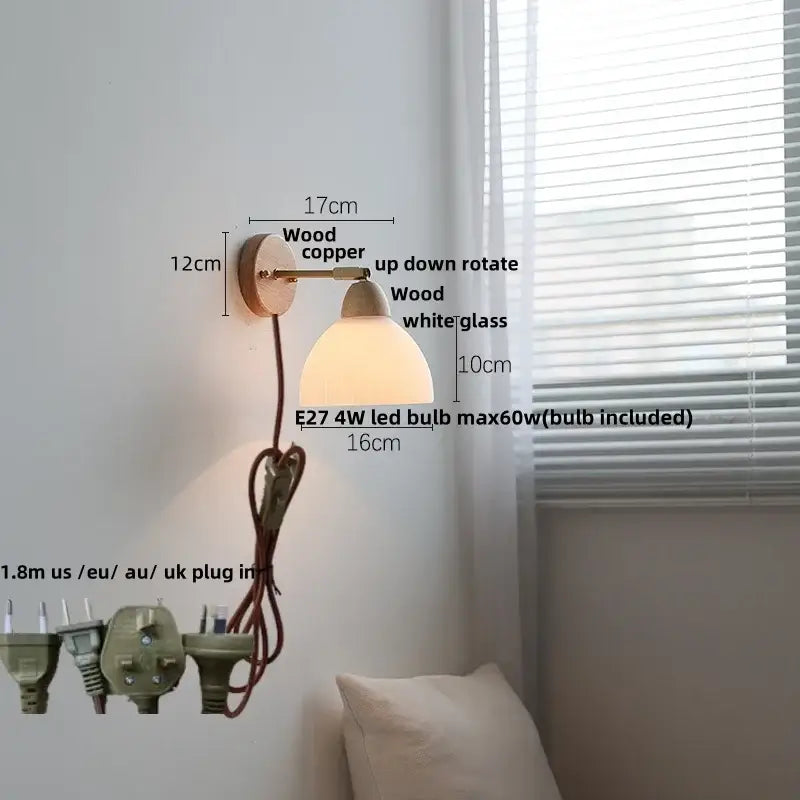 A warm-toned ribbed ceramic and wood wall sconce light with copper finish, white glass shade, and red cord for bedroom