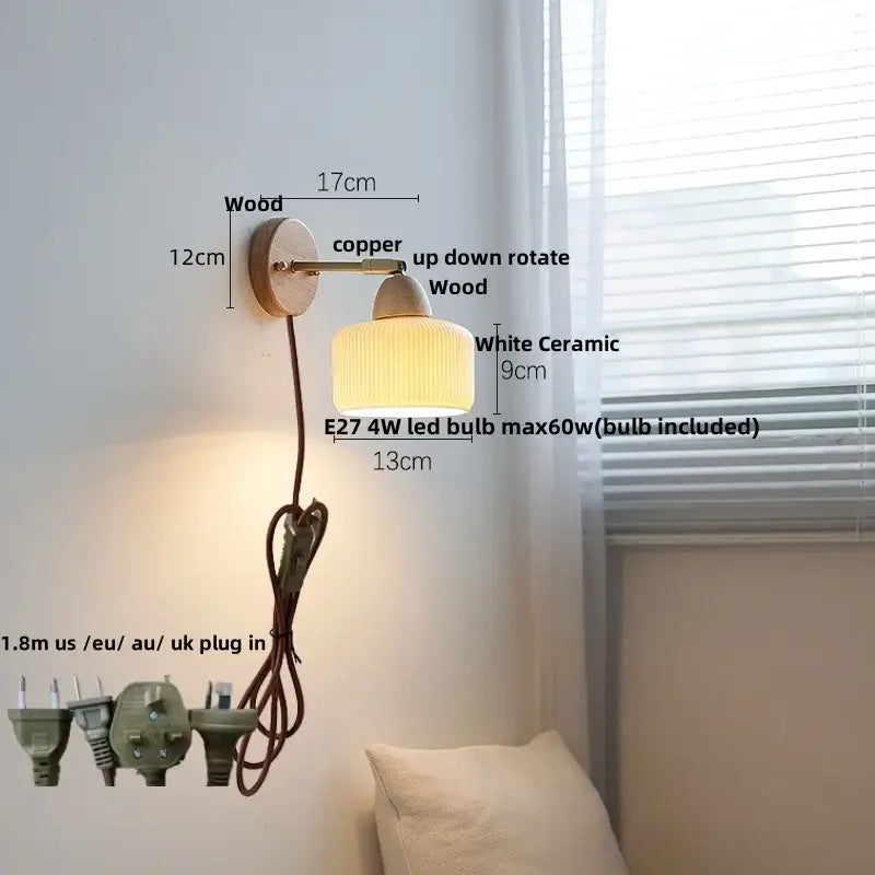 A warm-toned wall sconce light with ribbed white ceramic shade, wooden base, and copper arm for bedroom use