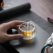 Clear ribbed double wall glass teacup set with vertical ridges and rounded flared rim for dining room use