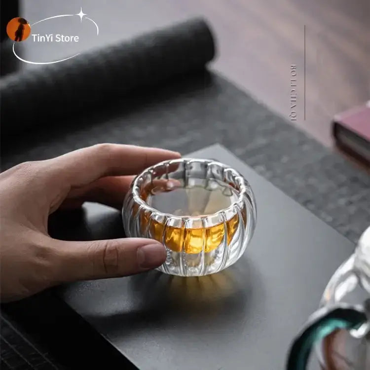 Clear ribbed double wall glass teacup set with vertical ridges and rounded flared rim for dining room use