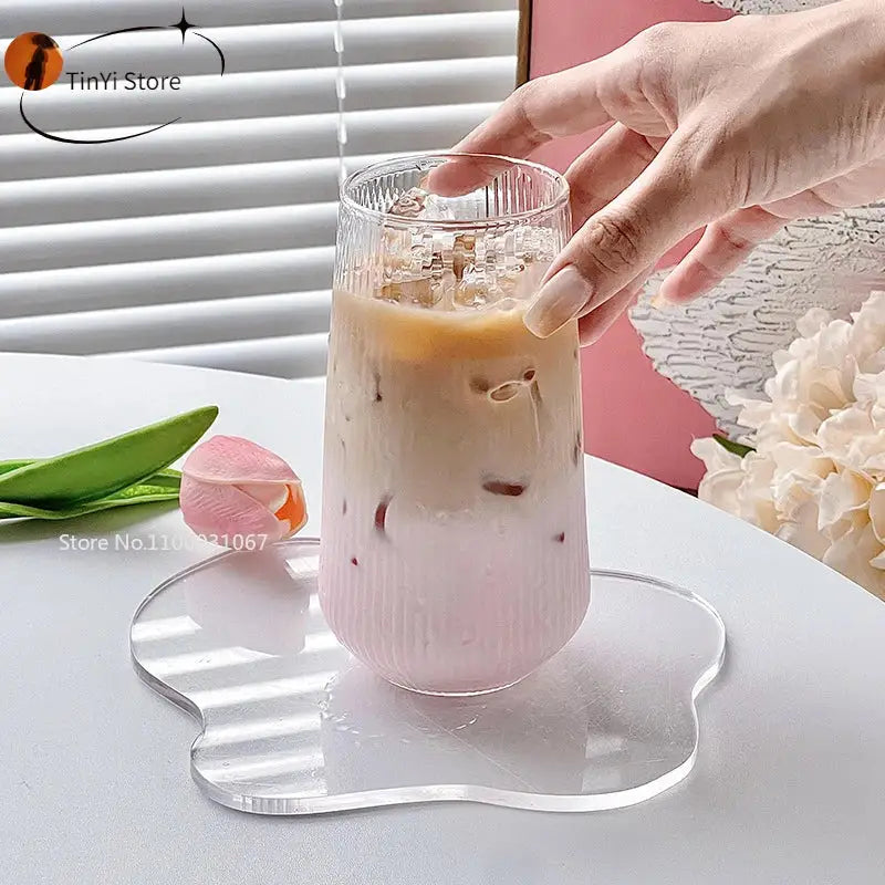 A decorbites clear glass ribbed tumbler filled with a pink and beige iced beverage for clear glass coffee use