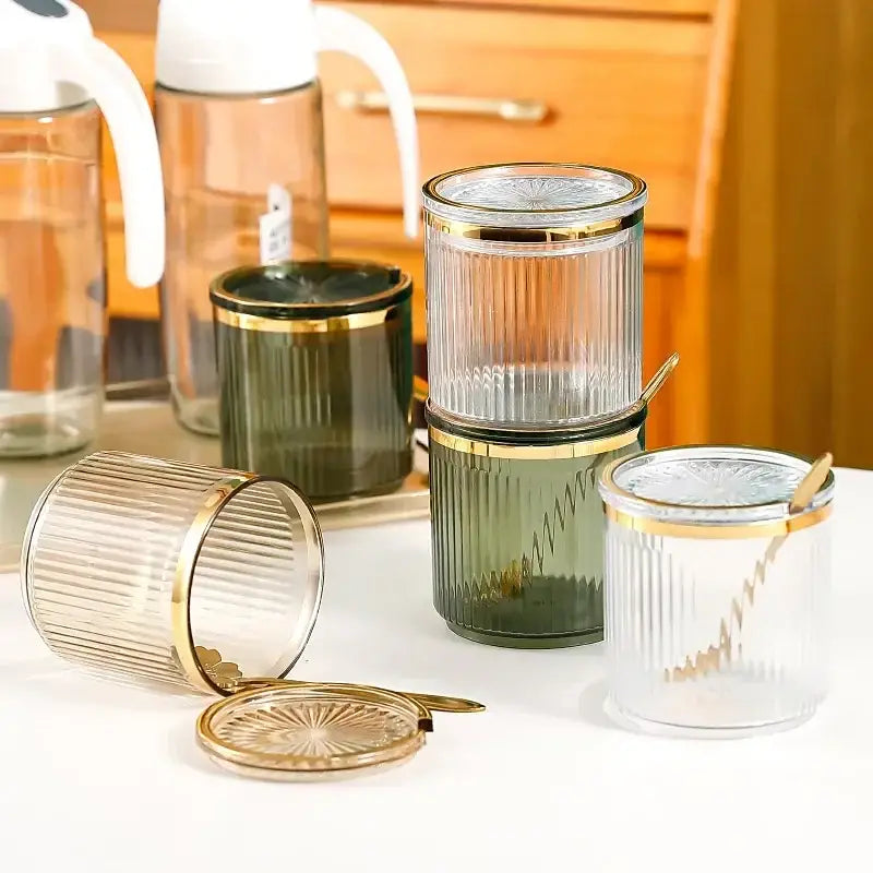 Ribbed clear and olive green acrylic seasoning jar set with gold-toned lids and spoons for kitchen storage decorbites acrylic seasoning