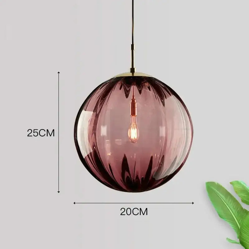 Amethyst-colored translucent glass ball pendant light with brass fixture and exposed filament bulb for living room decorbites glass ball