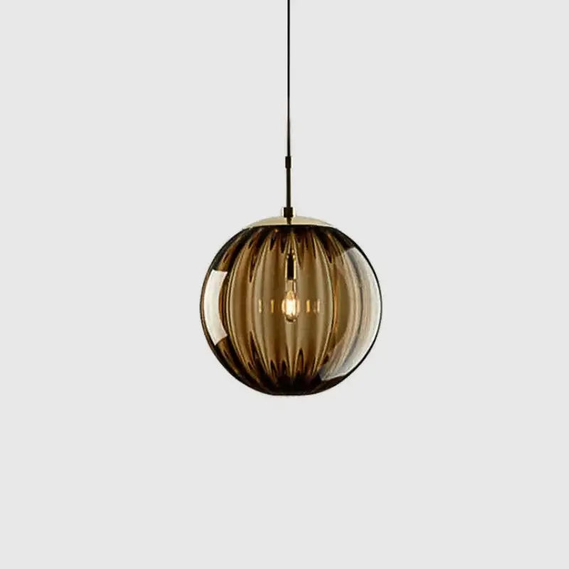 A sleek amber-tinted ribbed glass ball pendant light with brass finish ideal for living room decorbites pendant lamp