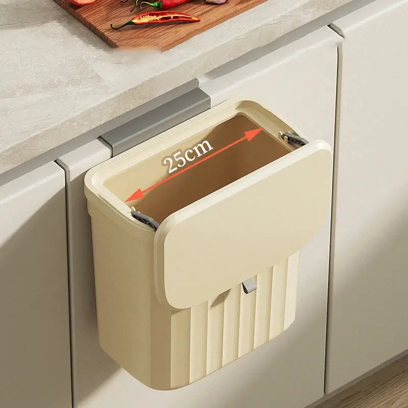 Cream-colored plastic kitchen cabinet hanging trash bin with hinged lid and vertical ribbed texture for decorbites kitchen cabinet