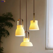 Three ribbed cream ceramic led pendant lights with brass accents hang from dark cords in kitchen decorbites ceramic led pendant design