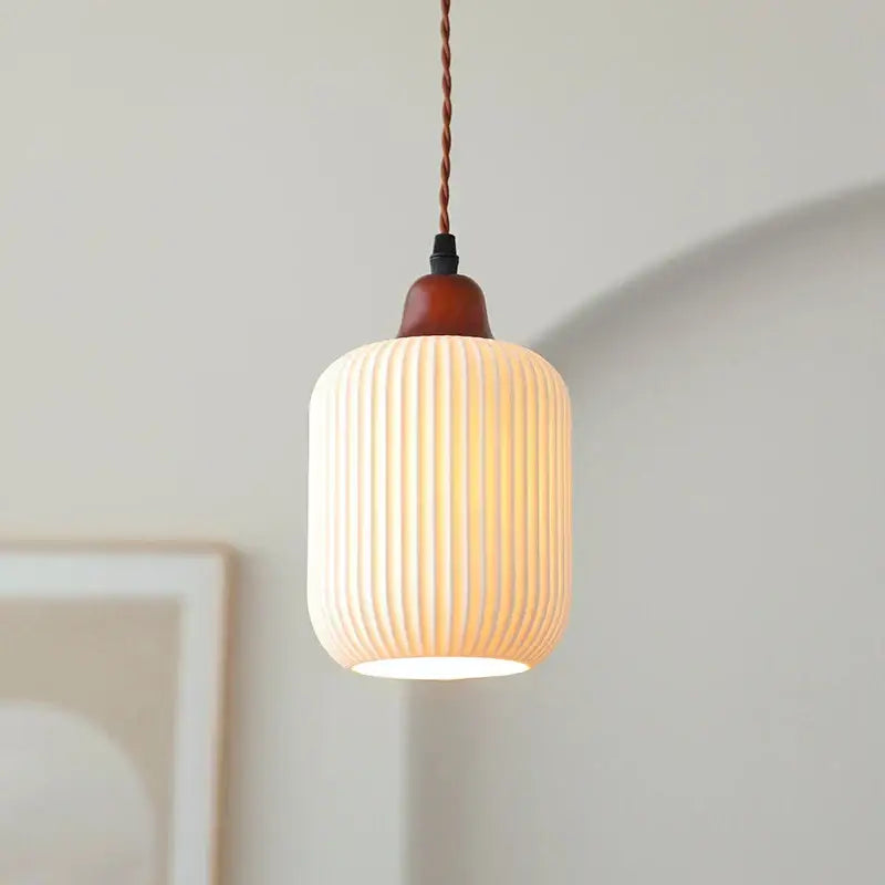 Cream-colored ribbed ceramic led pendant light with wood top and twisted copper cord for dining room decorbites ceramic led