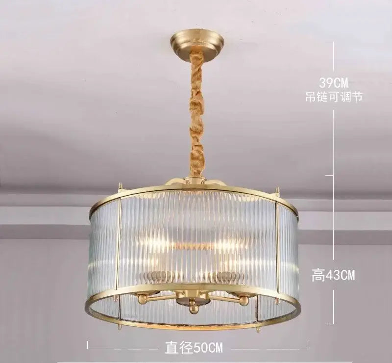 Gold-toned decorbites glass chandelier with ribbed cylindrical glass shade and twisted brass chain for living room pendant light